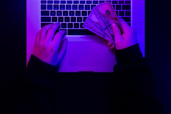 money-male-hands-background-laptop-keyboard-neon-lighting